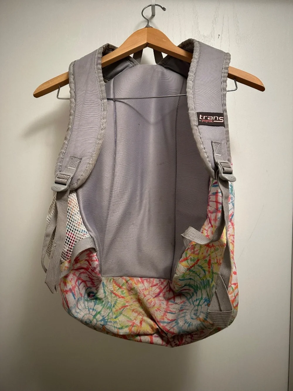 JanSport Trans backpack in a colorful multicolor floral/tie-dye style print